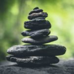 black stacking stones on gray surface